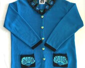 Stunning Storybook Knits handmade Peacock sweater. Blue w black collar. Glass bead peacocks, fringe feathers. Painted buttons.