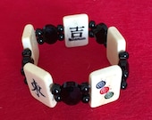 Good luck MAH JONGG tile bracelet. Carved and painted bone tiles, multi-faceted black jet oval beads and round black Czech glass beads.