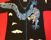 Dramatic Storybook Knits handmade Mah Jongg sweater. Jewel tones. Features dragon design. Faceted red bead eyes. Gold threads. Size S