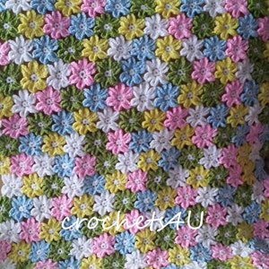 May include: A crocheted baby blanket with a flower pattern in shades of pink, blue, yellow, and green. The blanket is made with a soft yarn and has a delicate texture.