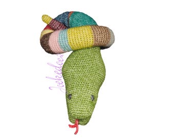 May include: A green crocheted snake toy with a multi-coloured striped head. The snake has a red tongue and black eyes.