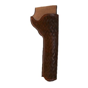 May include: A brown leather holster with a diamond-shaped quilted pattern. The holster has a white stitching detail around the edges.