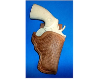 May include: A brown leather holster with a woven pattern, designed to hold a white revolver.