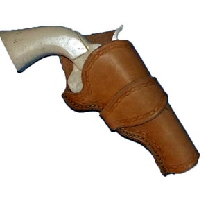 May include: A brown leather holster for a revolver. The holster has a stitched design and a belt loop.