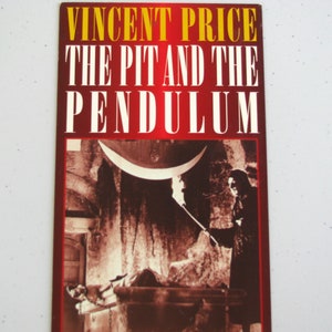 May include: A vintage movie poster for the film "The Pit and the Pendulum" starring Vincent Price. The poster features a black and white image of a man tied to a table with a large pendulum swinging above him. The text on the poster is in yellow and red.