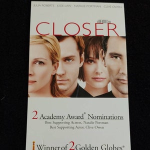 May include: A DVD cover for the film "Closer" starring Julia Roberts, Jude Law, Natalie Portman, and Clive Owen. The cover features a close-up of the four actors' faces. The text on the cover reads "2 Academy Award Nominations" and "Winner of 2 Golden Globes".