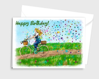 May include: A birthday card featuring a watercolor illustration of a person riding a bicycle through a field of flowers. The text "Happy Birthday!" is written in green letters at the top of the card.