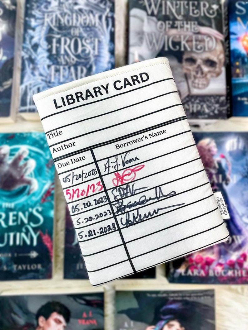 This photo is similar to the previous photo, but this one shows the back side of the sleeve with different dates and author signatures.  The has the same blank library card design on both sides so you can collect several signatures.