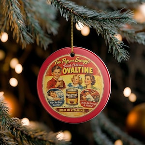 May include: A round red ceramic ornament featuring a vintage Ovaltine advertisement. The graphic displays a boy, a girl, and a woman, along with a can of Ovaltine, text reading For Pep and Energy, Drink Delicious Ovaltine, Helps You Sleep Soundly, and Builds Up Strength and Vitality.