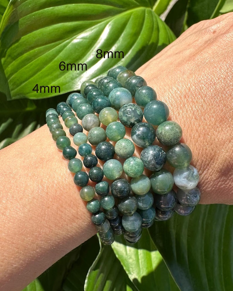 May include: A set of five green agate stone bracelets, each with a different size bead. The bracelets are labeled 4mm, 6mm, 8mm, 10mm, and 12mm.
