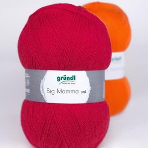 May include: Two balls of yarn, one red and one orange. The red ball has a label that says "gründl". "Big Mamma uni" is printed on the label.