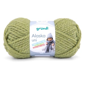 May include: A large skein of green yarn with a white label. The label features the text "gründl Alaska uni" and an illustration of a person wearing a hat and scarf. The yarn is a chunky knit, perfect for winter projects.