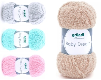 May include: Four balls of yarn in different colours: grey, light blue, pink, and beige. The yarn is soft and fluffy, and the label says "gründl Baby Dream".