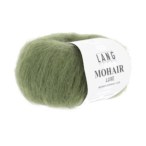 May include: A ball of olive green mohair yarn with a white label. The label reads "LANG YARNS MOHAIR LUXE MOHAIR SUPERKID / SILK". The yarn has a soft, fluffy texture, ideal for knitting or crocheting projects.