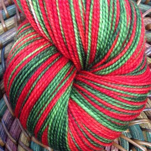 May include: A skein of yarn with alternating stripes of red and green.