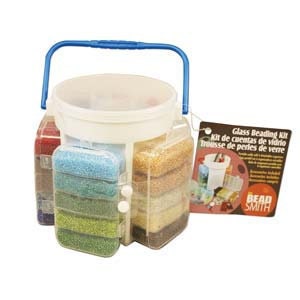 May include: A white plastic bucket with a blue handle filled with small glass beads in various colors. The bucket has six clear compartments for storing the beads. The label on the front reads "Glass Beading Kit, Kit de cuentas de vidrio, Trousse de perles de verre, Bead Smith."
