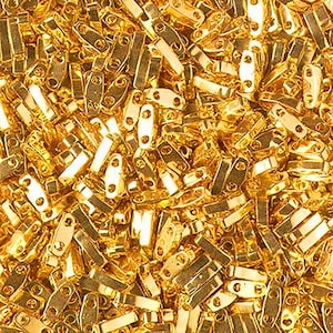 May include: A large collection of small, metallic gold-colored beads, each featuring a rectangular shape with rounded ends and two distinct holes drilled through the center, creating a uniform, reflective, and shiny surface texture throughout.
