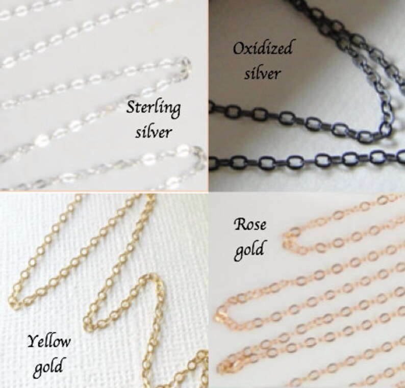 May include: Close-up of four different chain styles: sterling silver, oxidized silver, yellow gold, and rose gold. Each chain is displayed with its respective label. The chains are delicate and have a variety of link shapes.