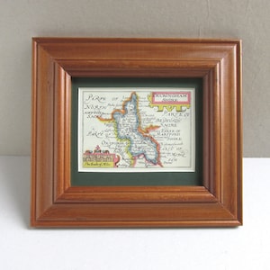 May include: A framed antique map of Buckinghamshire, England, with a green mount and a wooden frame. The map shows the surrounding counties of Northampton, Bedford, Oxford, and Hertford.