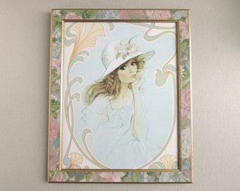 Framed Vintage Art Print of Woman in Wide Brim Hat, Brown Hair and Big Eyes, 1970s Popular Style, 16 1/4 x 13 1/8 inches max