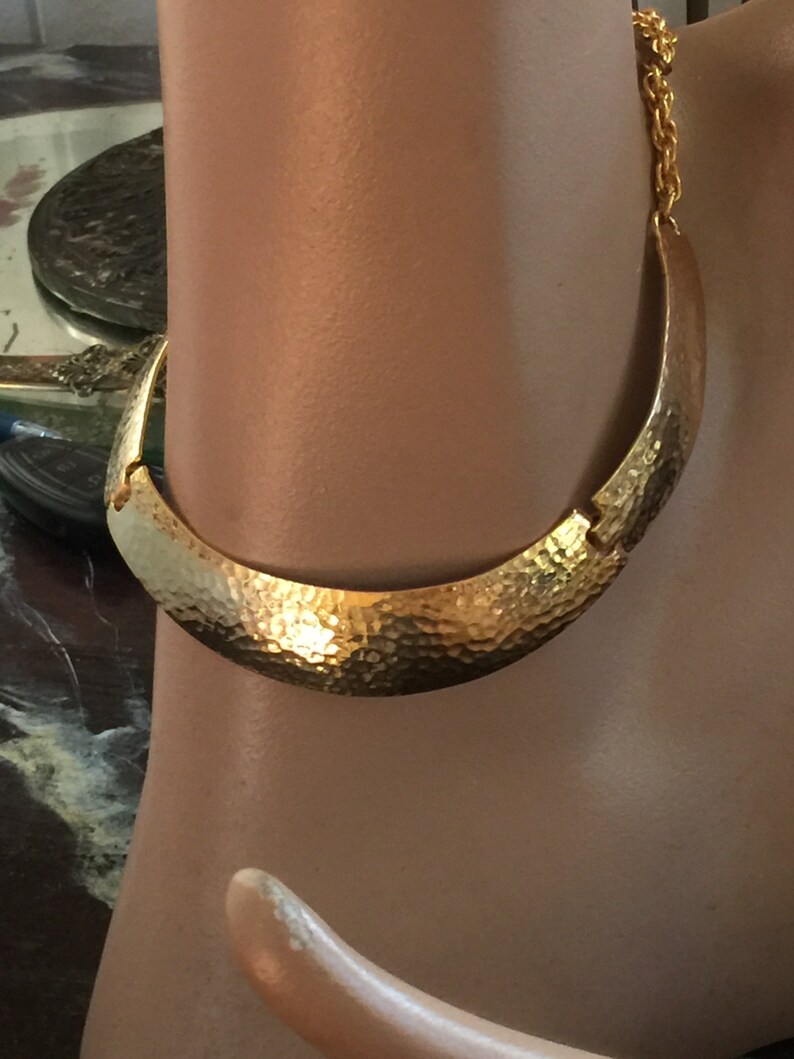 A gold plated necklace from the 60s Mod in hammered metal,collar form