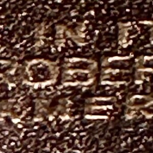 May include: Close-up of a brown leather tag with the text "PROPERTY OF KERNO" embossed in white.