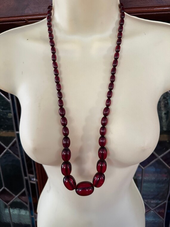 A smooth beaded cherry graduated bakelite necklace