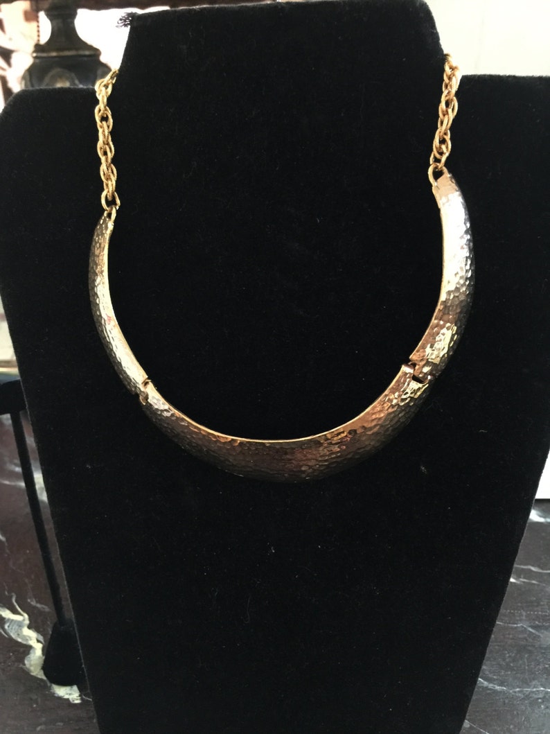 A gold plated necklace from the 60s Mod in hammered metal,collar form
