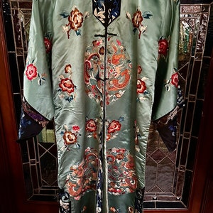 Late Qing dynasty coat in blue and black with hand embroidery and five toe dragon from China.