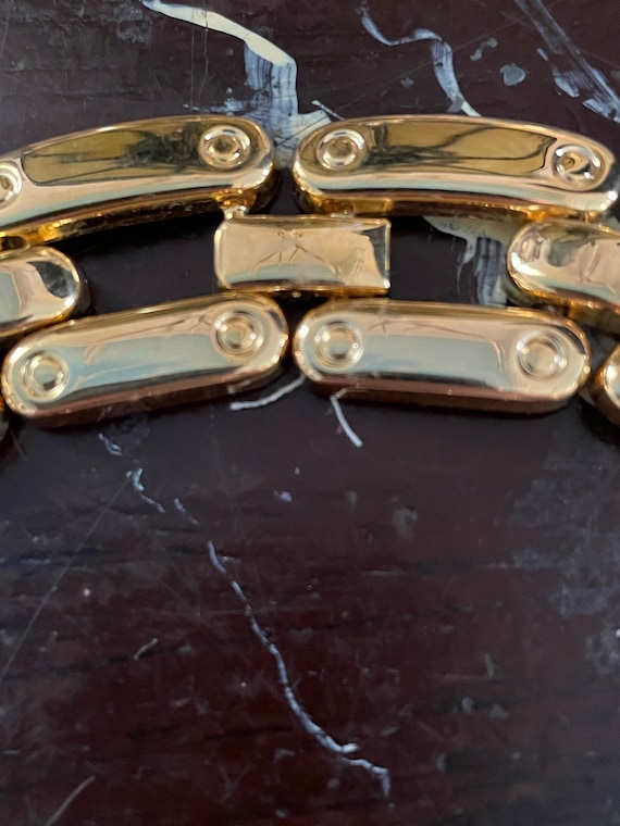 Gold chunky link chain circa 1980s,which lays at nape… Gem