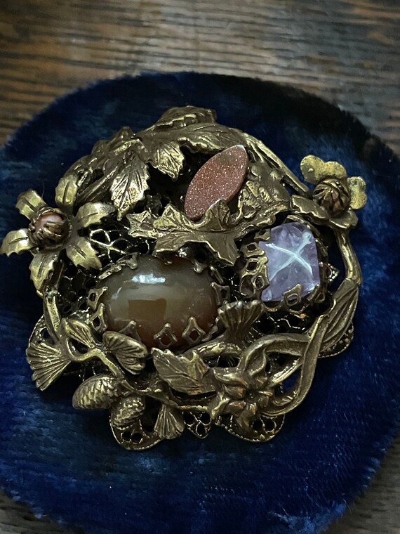 Brass brooch in floral motif with goldstone,amythe
