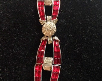 1940s bracelet with red baguettes and clear rhinestones set in Rhodium and marked pat pend