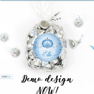 May include: A blue and silver printable sticker design featuring a Cinderella carriage and the name "Ella". The sticker is designed to be printed on sticker paper and used as a favor for a birthday party.