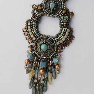 May include: Ornate beaded necklace with a circular pendant and dangling accents. The necklace features teal, brown, and gold beads, with a central turquoise stone. The design includes a variety of bead shapes and textures, creating a detailed and artistic piece.