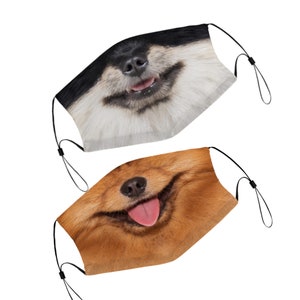 May include: Two face masks with dog faces printed on them. The top mask has a black and white dog face with a pink tongue sticking out. The bottom mask has a brown dog face with a pink tongue sticking out.