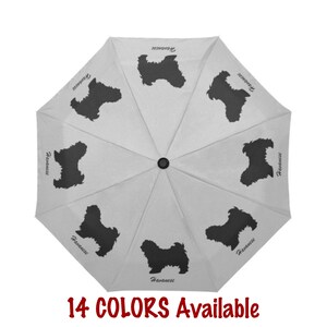 May include: A white umbrella featuring a repeating pattern of black Havanese dog silhouettes. The word "Havanese" is printed near each dog. The text "14 COLORS Available" is displayed in red at the bottom of the image.
