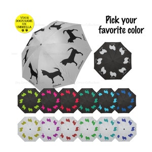 May include: A collection of umbrellas featuring dog silhouettes. The main umbrella is white with black Chihuahua dog silhouettes. Other umbrellas are black or white with various dog breeds in different colors. Text on the umbrella says "Your Dog's Name on Umbrella."