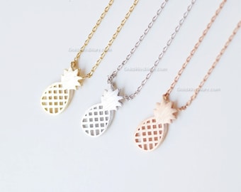 May include: Three gold, silver, and rose gold pineapple necklaces with delicate chain links. The pineapple pendants are hollow and have a grid pattern.