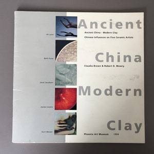 May include: A book cover titled "Ancient China Modern Clay" with text and images. The cover features the title, author names, and the Phoenix Art Museum logo. The cover has a gray background with images and text in white and black.