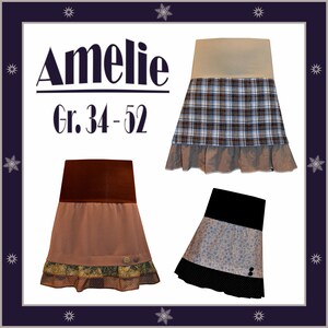 May include: Three different skirts with ruffles and different patterns. The skirts are brown, beige, and black with white polka dots. The text "Amelie Gr. 34-52" is at the top of the image.