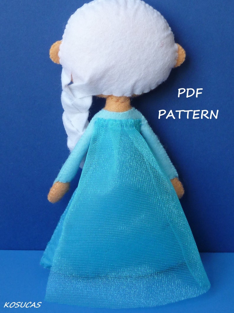 May include: A blue felt doll with white hair and a blue tulle skirt. The doll is wearing a blue dress and has a braid in her hair. The text "PDF PATTERN" is visible in the image.