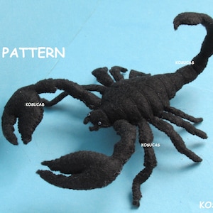 May include: Black felt scorpion with a curled tail. The scorpion is a handmade craft item and is a PDF pattern.
