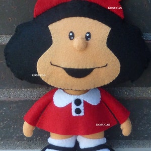May include: A felt doll pattern for a girl with black hair, a red dress, and white shoes. The pattern includes the text "PDF PATTERN" and the name "KOSUCAS" repeated throughout.