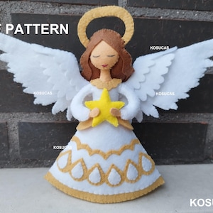 May include: A white felt angel with a gold halo and a yellow star. The angel is holding the star in its hands. The angel is wearing a white dress with gold trim. The angel is standing on a brick wall. PDF PATTERN.
