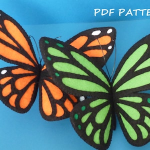 May include: Two felt butterfly patterns, one orange and black, the other green and black, with the text "PDF PATTERN" at the top of the image.