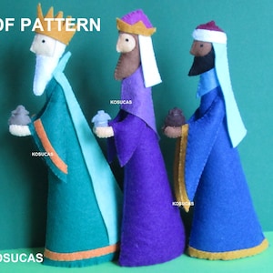 May include: Three felt Christmas Wise Men figures, each wearing a crown and holding a gift. The Wise Men are dressed in blue, purple, and green robes with gold trim. The text "PDF PATTERN" is at the top of the image.