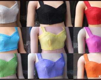 May include: A collection of nine doll-sized crop tops in various colors, including white, black, red, blue, yellow, pink, green, purple, and orange. Each top features a sweetheart neckline and wide straps.