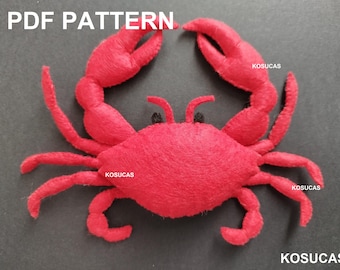 May include: A red felt crab with black eyes. The crab is a sewing pattern for a plush toy.
