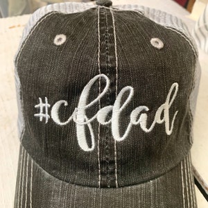 May include: A black and white trucker hat with a white embroidered design that says "#cfdad".