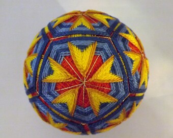 Japanese Temari Ball handmade rice hulls with a bell inside 30 woven yellow petals into blue pentagons over red
